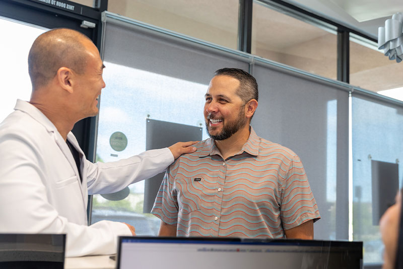 Patient and Doctor discussing at the front desk of the dental practice